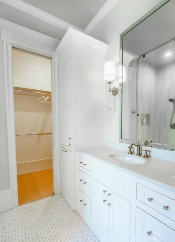 a bathroom with a double vanity sink a mirror and a shower