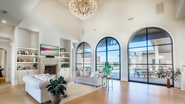 a living room with furniture fireplace and wooden floor