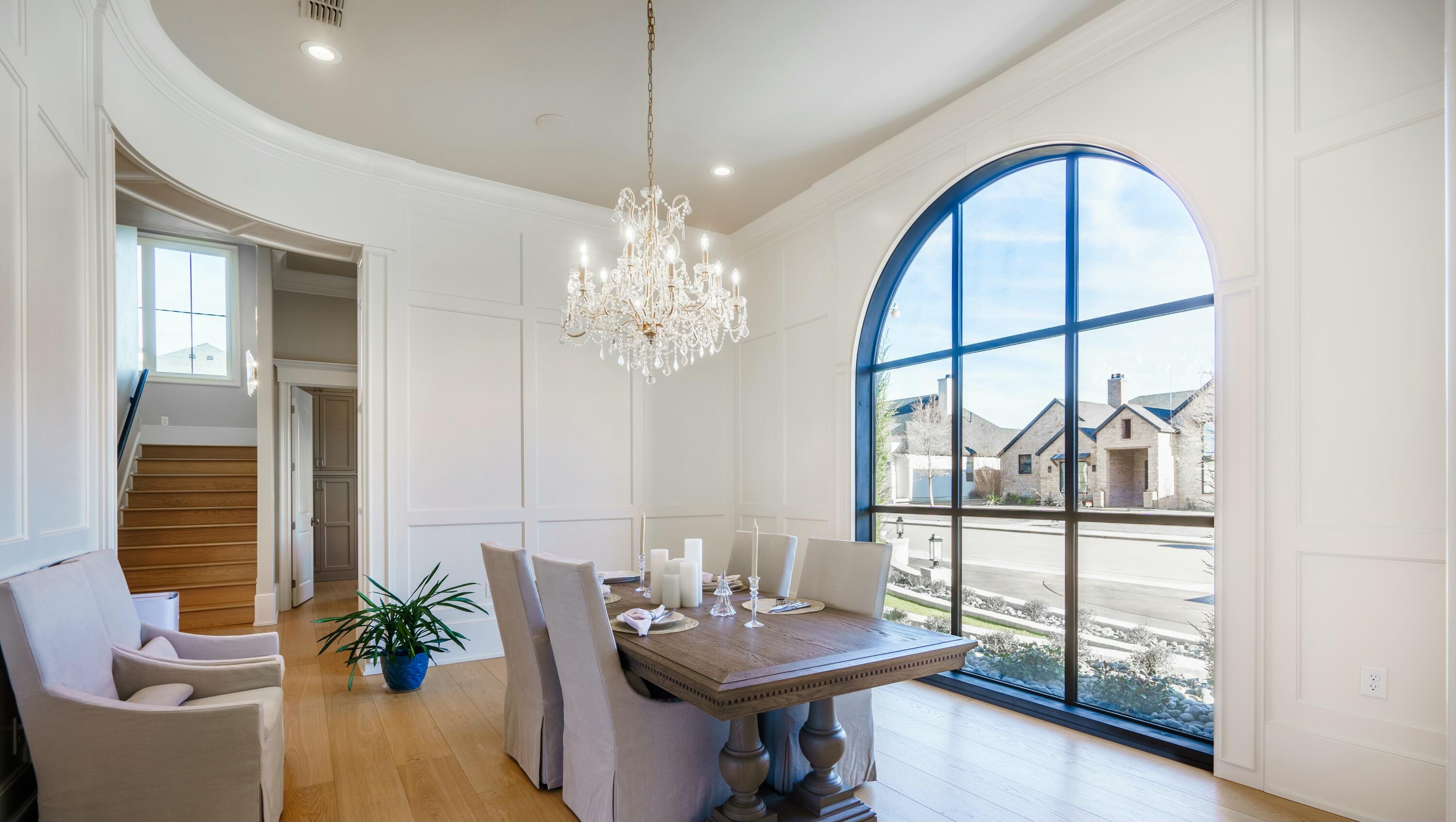 4011 140th Street Lubbock, TX 79423 - Photo 9 of 52 a view of a dining room with furniture a chandelier and wooden floor