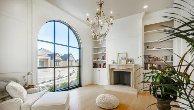 a living room with furniture a chandelier and a fireplace