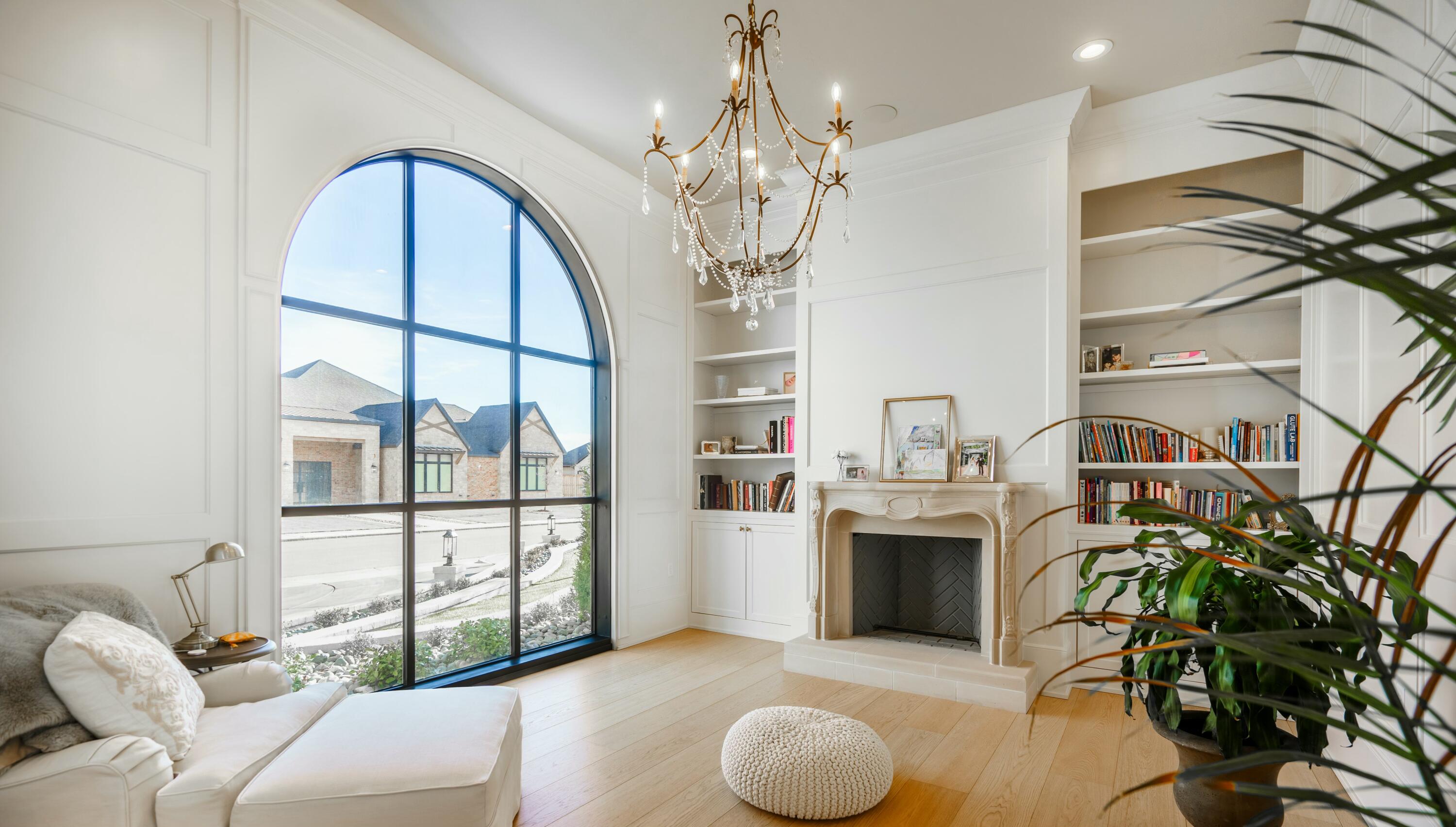 4011 140th Street Lubbock, TX 79423 - Photo 10 of 52 a living room with furniture a chandelier and a fireplace