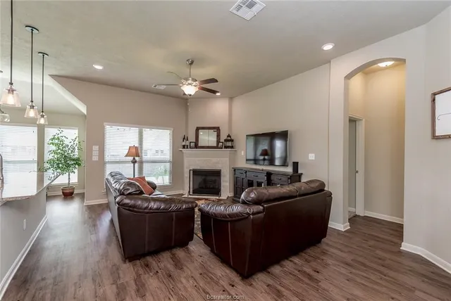 a living room with furniture fireplace and flat screen tv
