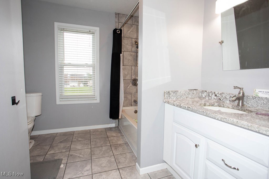 125 Ridgeway Street Struthers, OH 44471 - Photo 17 of 24 Full bathroom featuring tile patterned floors, shower / bath combo, toilet, and vanity