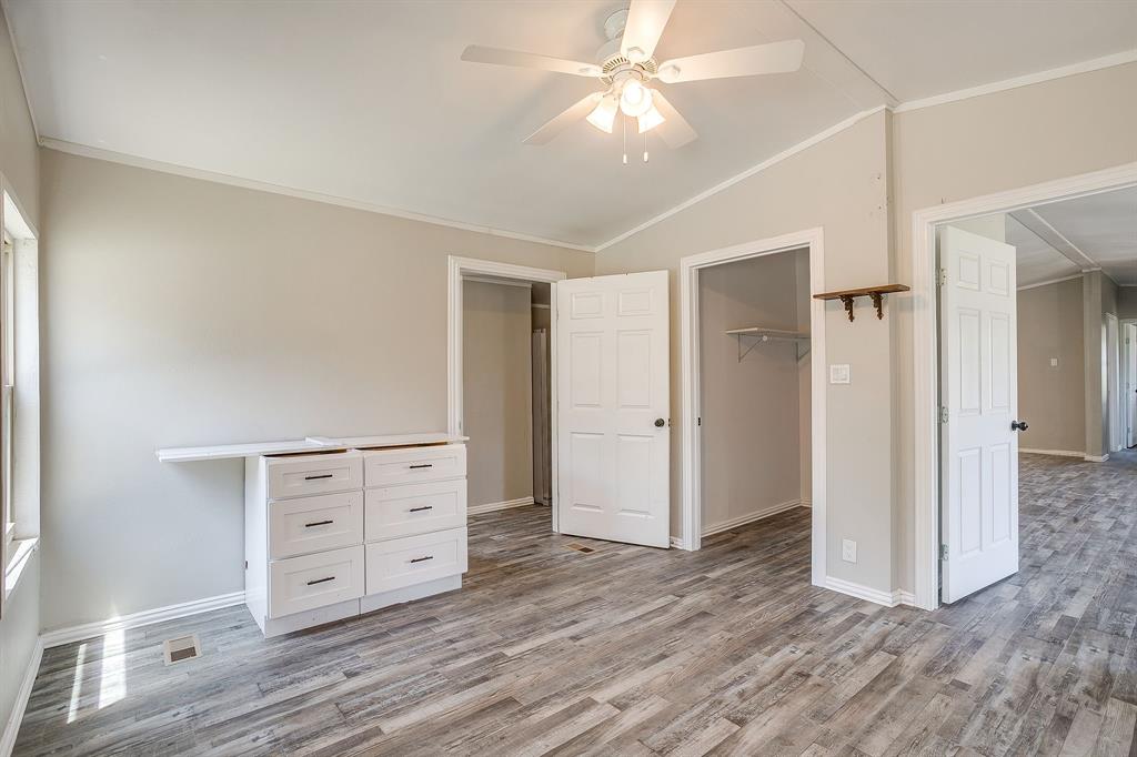 178 Valley Lake Lane Springtown, TX 76082 - Photo 18 of 33 Spacious room featuring wood-finish flooring, vaulted ceilings, and a ceiling fan with integrated lighting