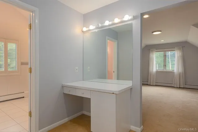 a bathroom with a sink a vanity and a mirror
