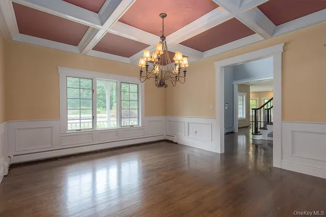 a view of livingroom with wooden floor and chandelier