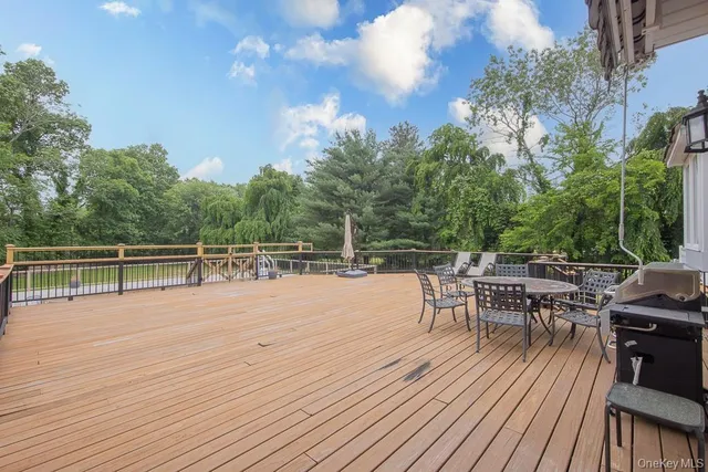 a view of a patio with dining table and chairs with wooden floor