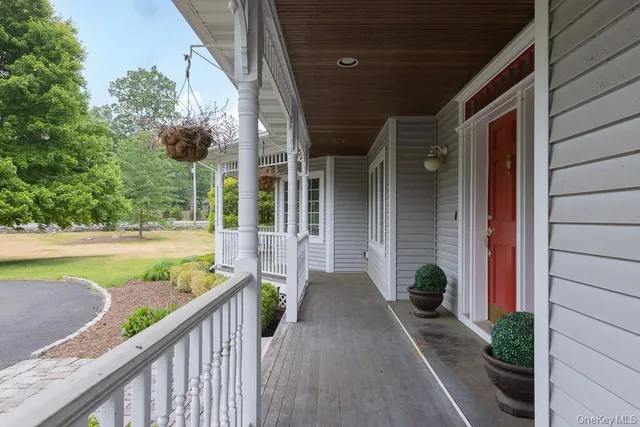 a view of a house with a yard and potted plants