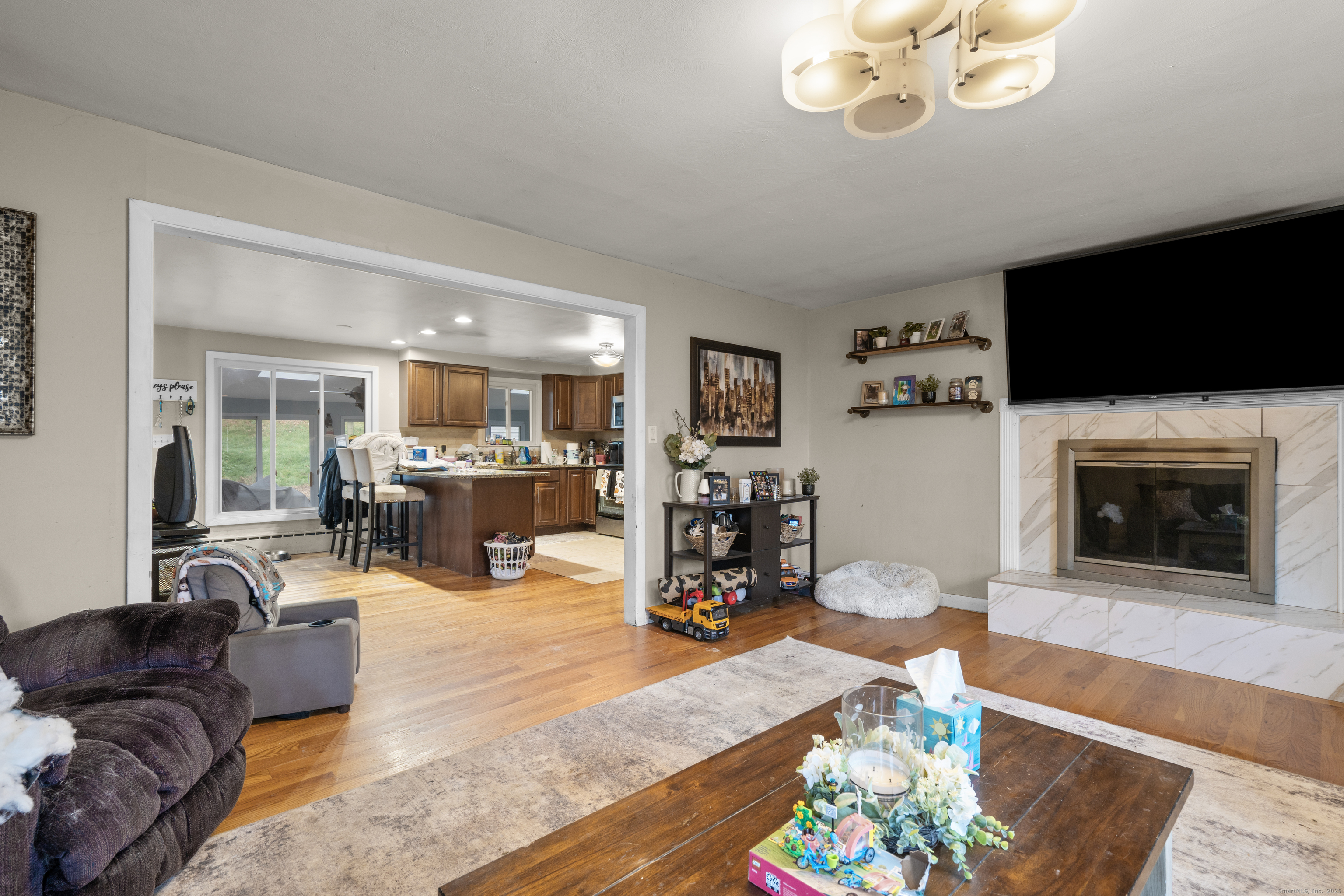 523 Chamberlain Hill Road Haddam, CT 06441 - Photo 12 of 38 a living room with furniture and a flat screen tv