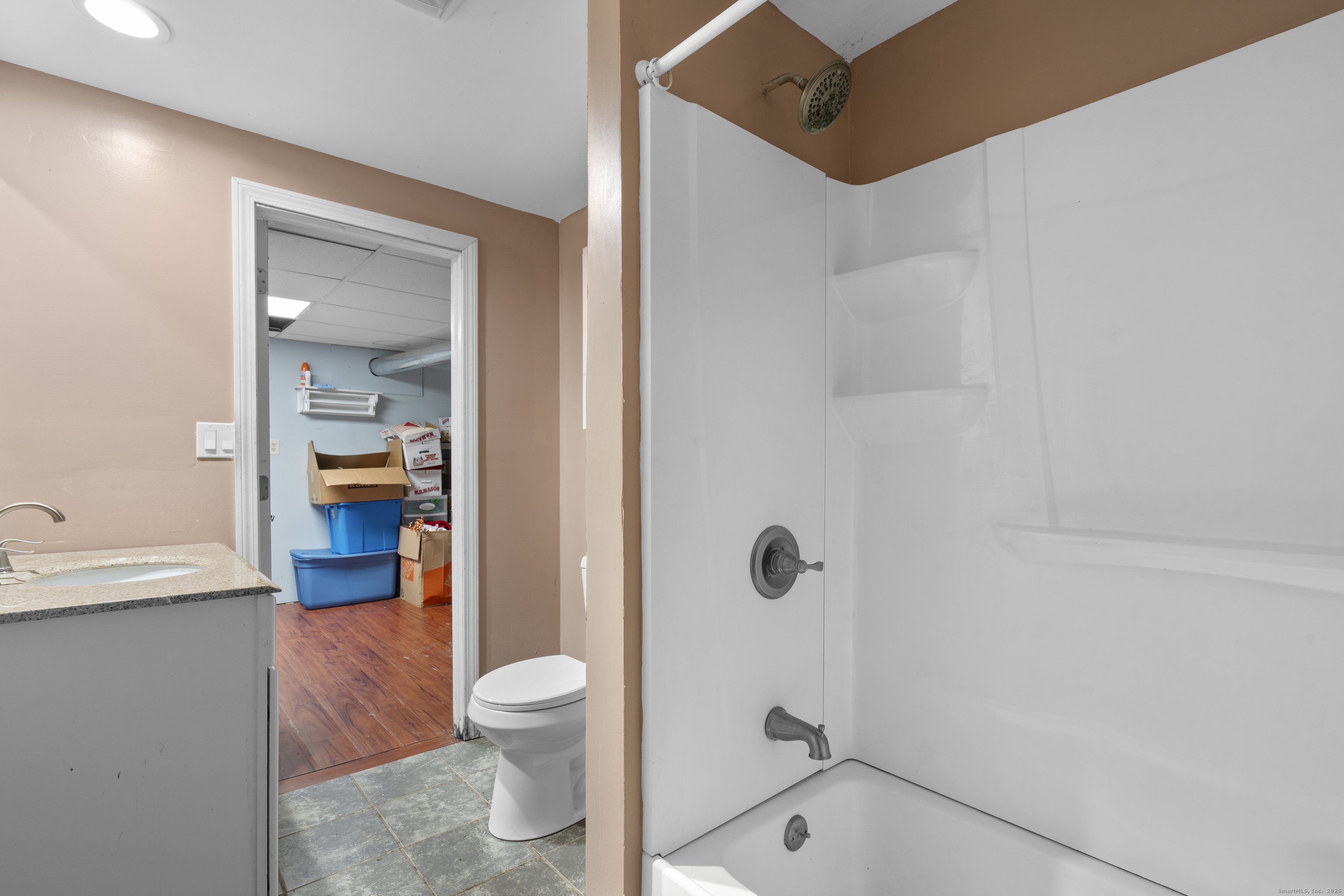 523 Chamberlain Hill Road Haddam, CT 06441 - Photo 33 of 38 a bathroom with a granite countertop toilet a sink and shower