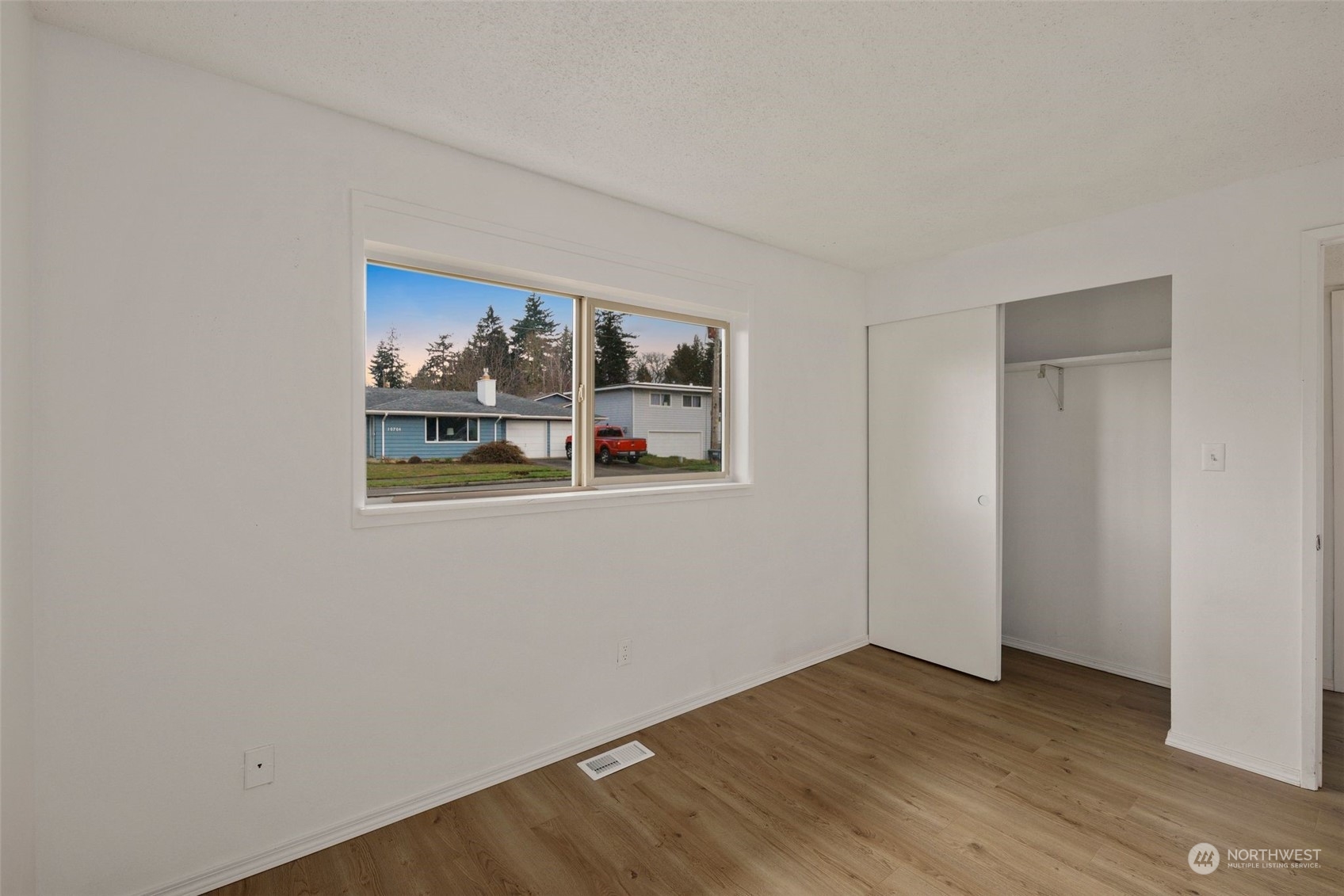 10705 Southeast 236th Place Kent, WA 98031 - Photo 13 of 36 a view of empty room with wooden floor and fan