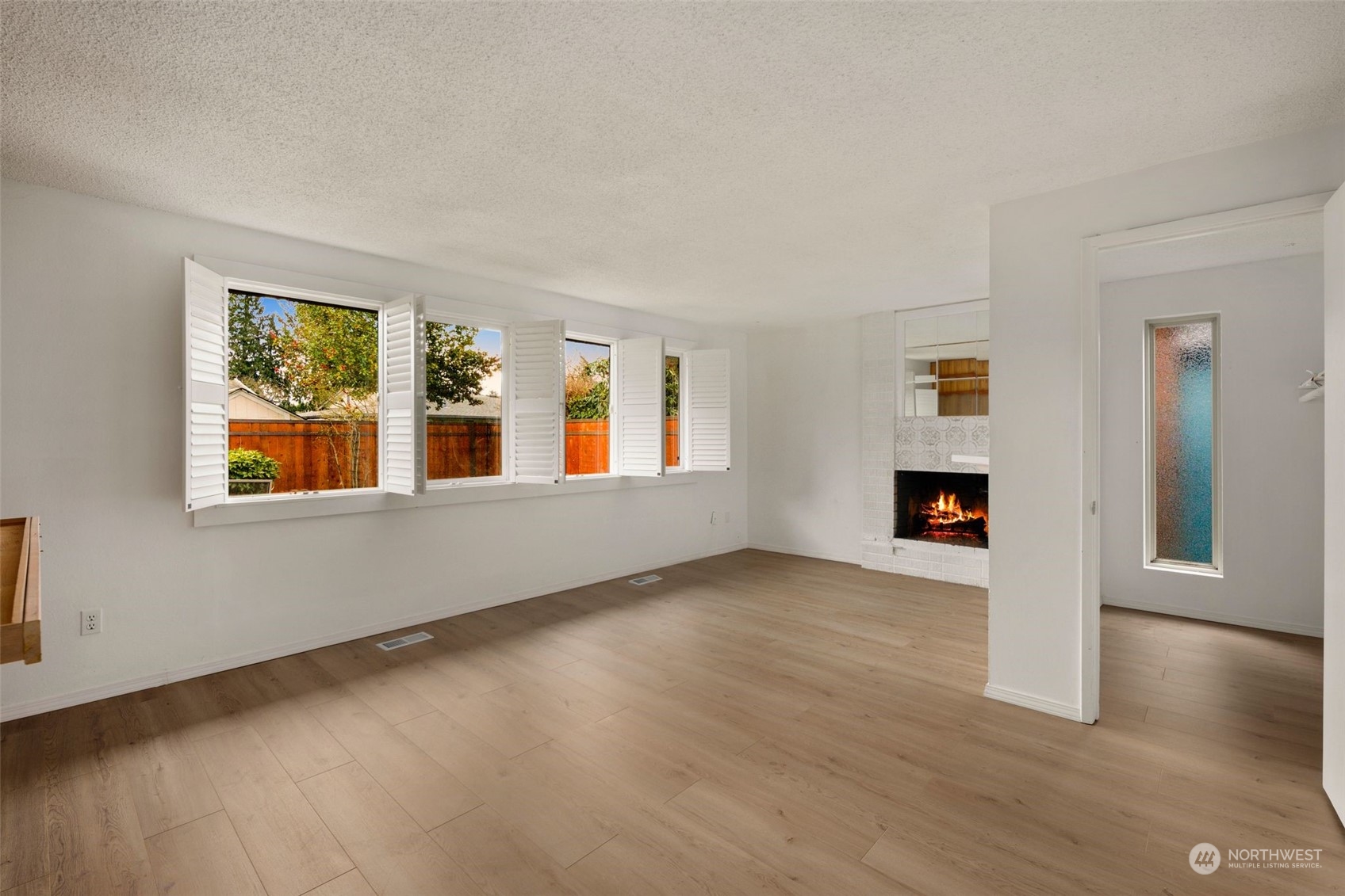 10705 Southeast 236th Place Kent, WA 98031 - Photo 14 of 36 a view of an empty room with window and wooden floor