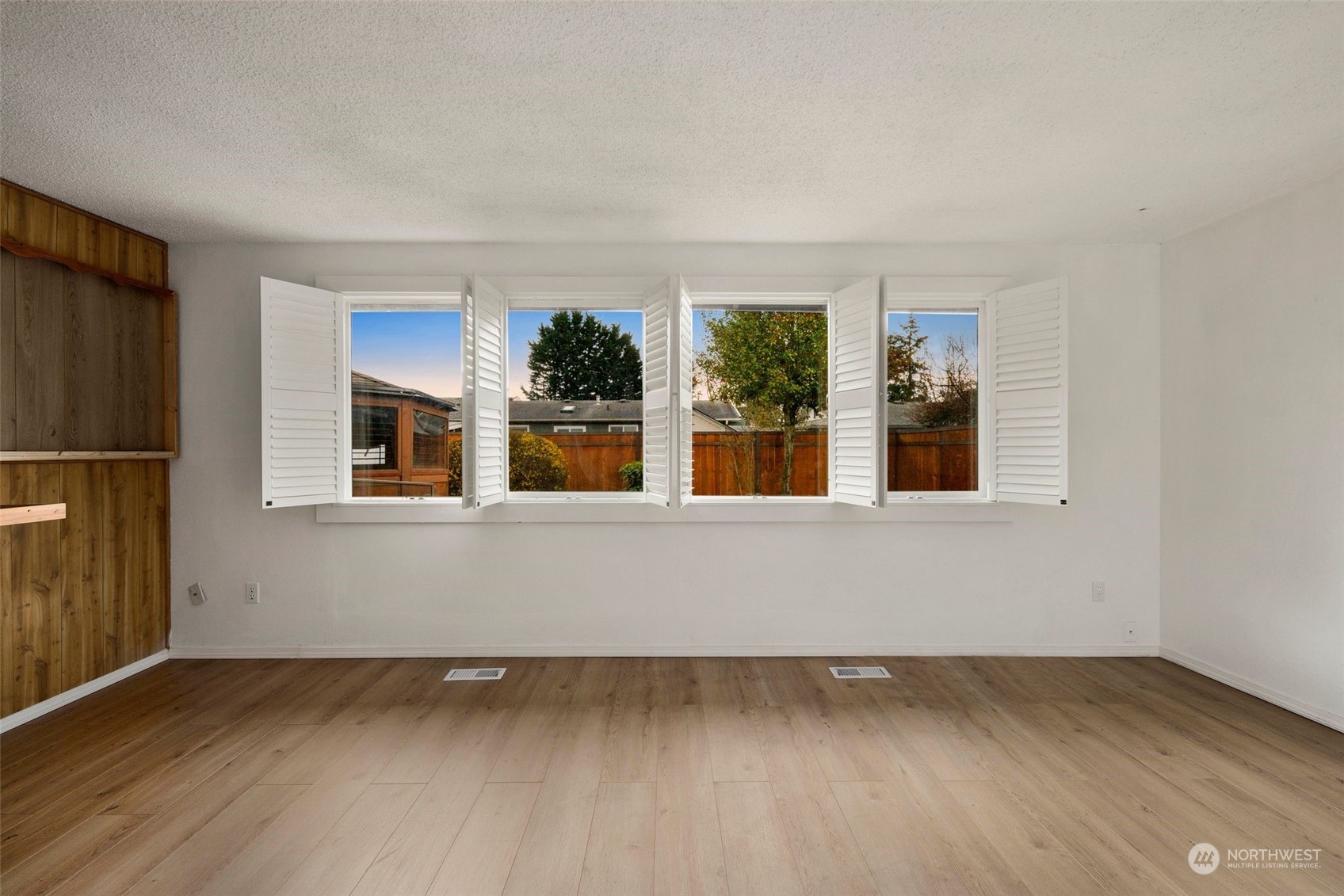10705 Southeast 236th Place Kent, WA 98031 - Photo 17 of 36 a view of an empty room with wooden floor and a window
