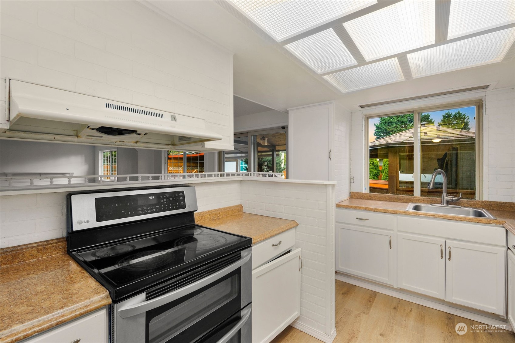 10705 Southeast 236th Place Kent, WA 98031 - Photo 20 of 36 a kitchen with wooden cabinets and a stove top oven