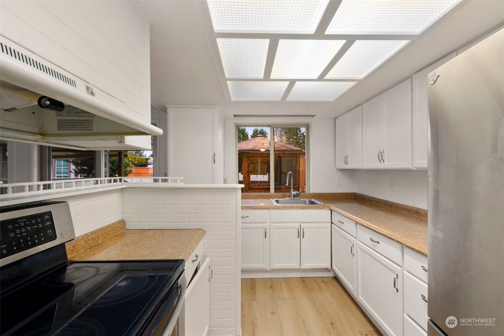 10705 Southeast 236th Place Kent, WA 98031 - Photo 21 of 36 a kitchen with stainless steel appliances granite countertop a sink and cabinets