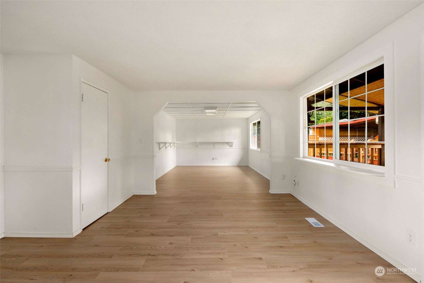 10705 Southeast 236th Place Kent, WA 98031 - Photo 23 of 36 a view of empty room with wooden floor and windows