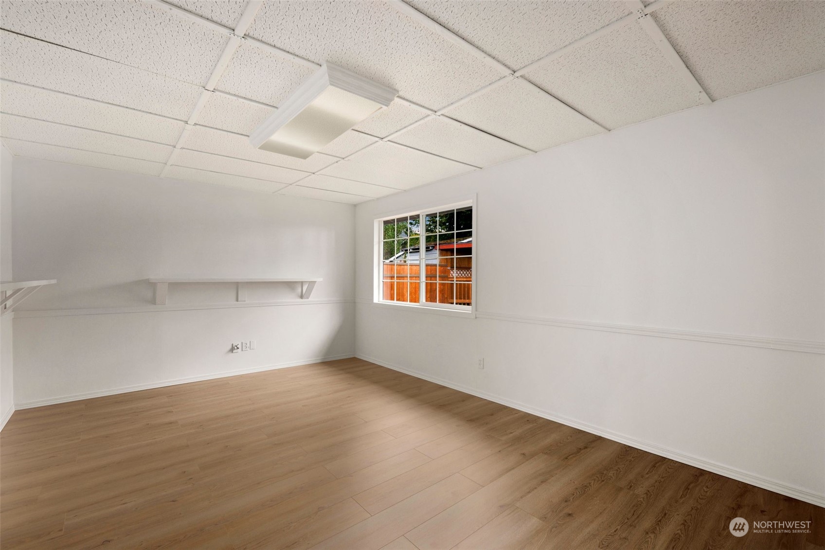 10705 Southeast 236th Place Kent, WA 98031 - Photo 24 of 36 an empty room with wooden floor and windows