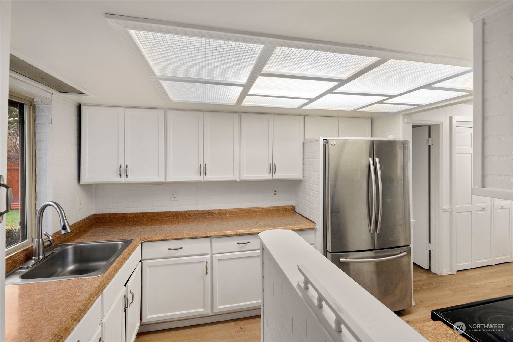 10705 Southeast 236th Place Kent, WA 98031 - Photo 26 of 36 a kitchen with a refrigerator sink and cabinets