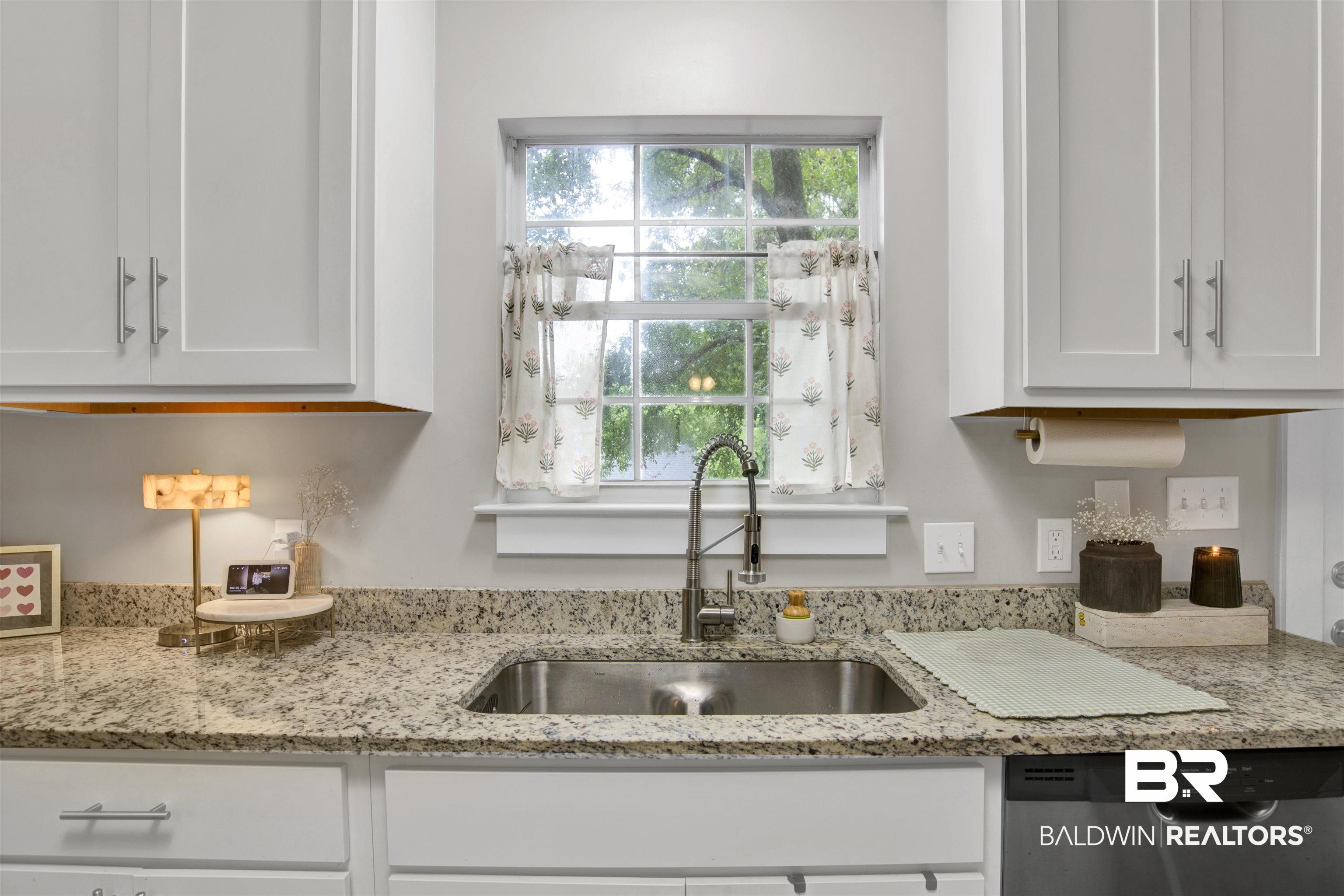 253 Maplewood Loop Daphne, AL 36526 - Photo 11 of 30 Kitchen featuring a stainless steel sink with a gooseneck faucet, light granite countertops, white shaker-style cabinetry with brushed nickel hardware, and a built-in dishwasher
