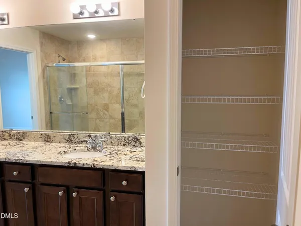 a bathroom with a granite countertop shower sink and vanity