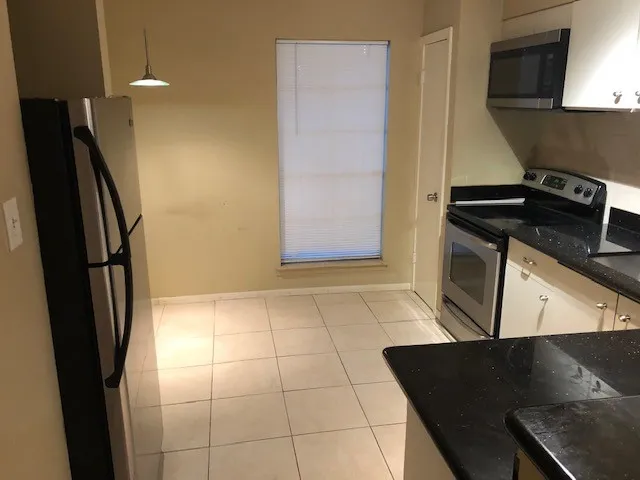 a kitchen with a stove and a refrigerator