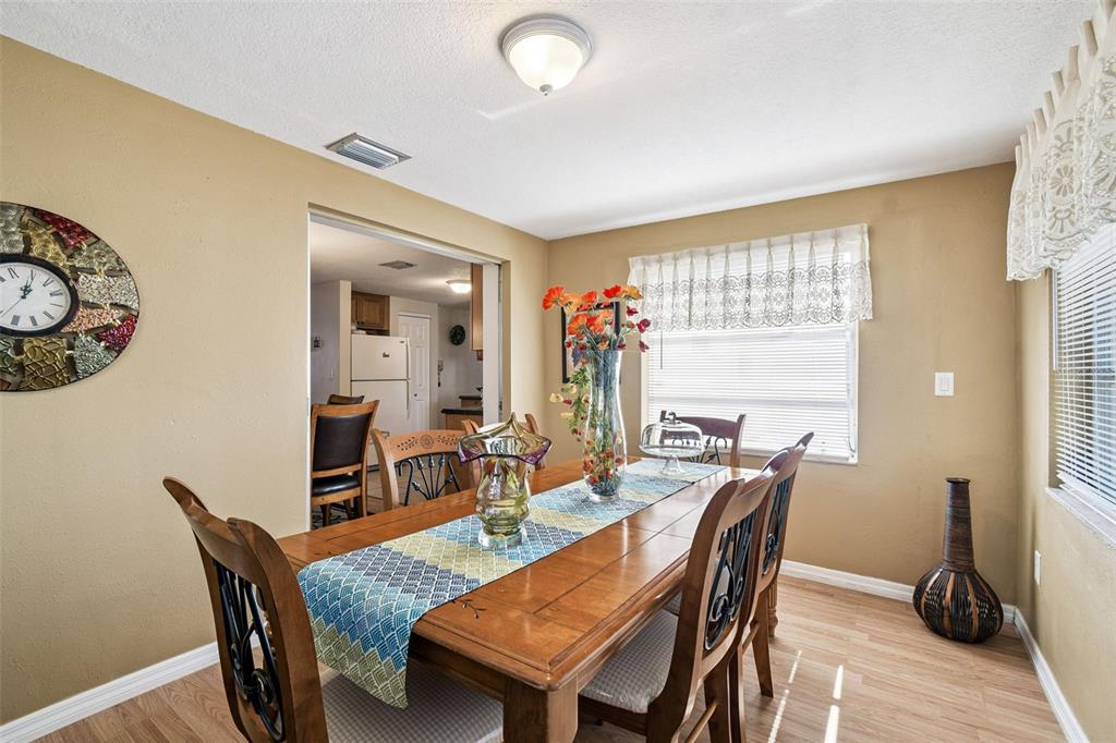 10801 Bethel Street Port Richey, FL 34668 - Photo 17 of 28 a view of a dining room with furniture and window