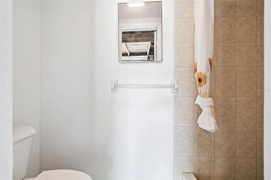 10801 Bethel Street Port Richey, FL 34668 - Photo 23 of 28 a bathroom with a toilet and a shower