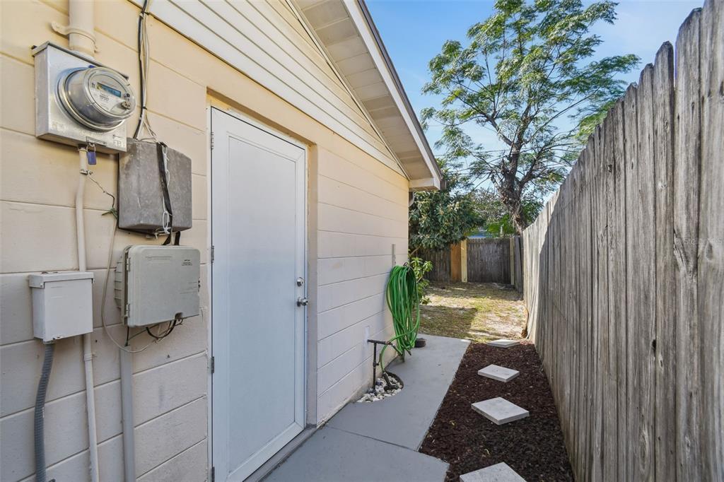 10801 Bethel Street Port Richey, FL 34668 - Photo 25 of 28 a backyard of a house with barbeque oven table and chairs