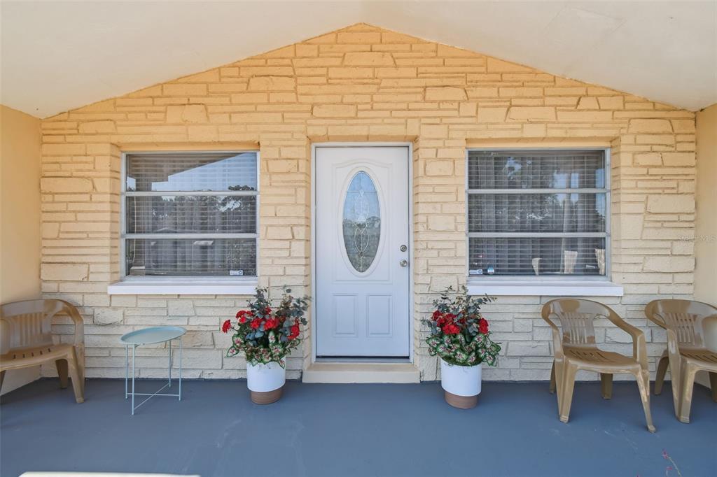 10801 Bethel Street Port Richey, FL 34668 - Photo 3 of 28 a front view of a house with outdoor seating