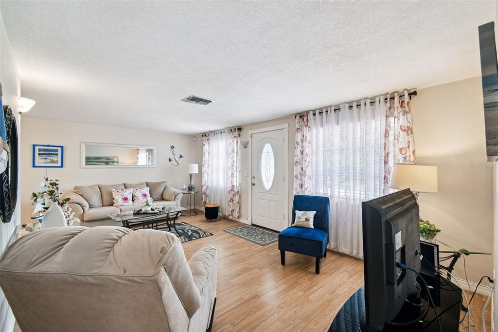 10801 Bethel Street Port Richey, FL 34668 - Photo 5 of 28 a bedroom with furniture and a window