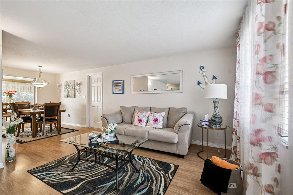 10801 Bethel Street Port Richey, FL 34668 - Photo 7 of 28 a living room with furniture and a couch