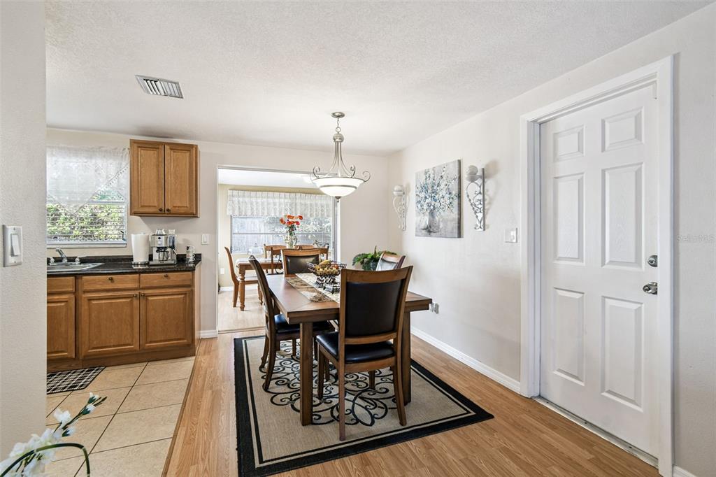 10801 Bethel Street Port Richey, FL 34668 - Photo 9 of 28 a view of a dining room with furniture and wooden floor