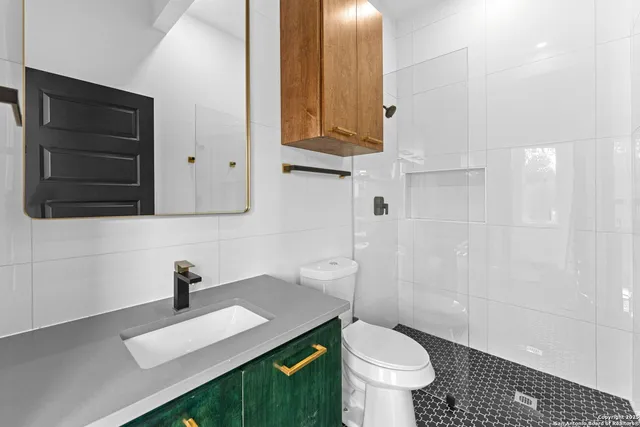 a bathroom with a sink toilet and shower