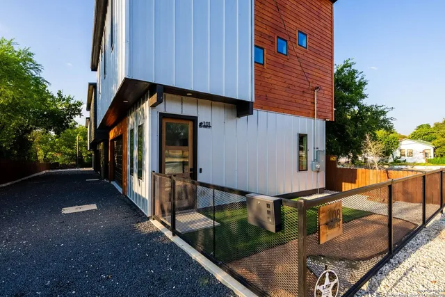 a view of a house with wooden floor next to a yard