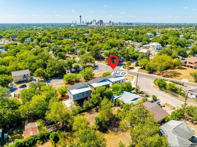an aerial view of residential houses with outdoor space