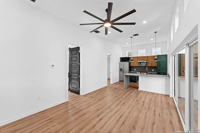a view of empty room with wooden floor