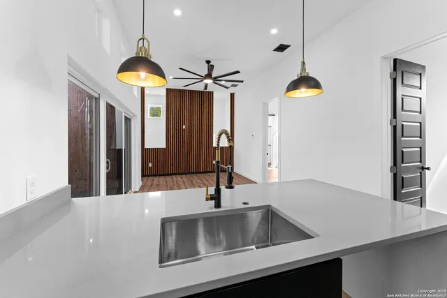 a kitchen with a sink and a refrigerator