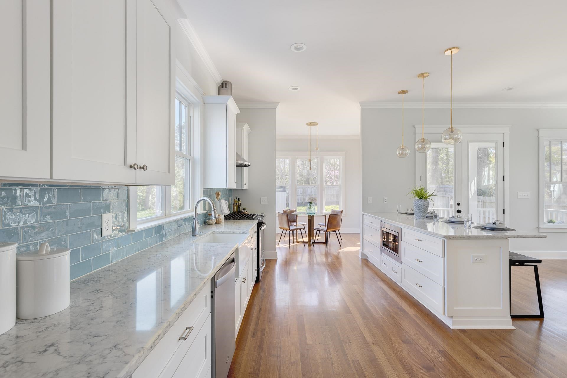 910 Sedgefield Street Durham, NC 27705 - Photo 11 of 39 a large white kitchen with stainless steel appliances