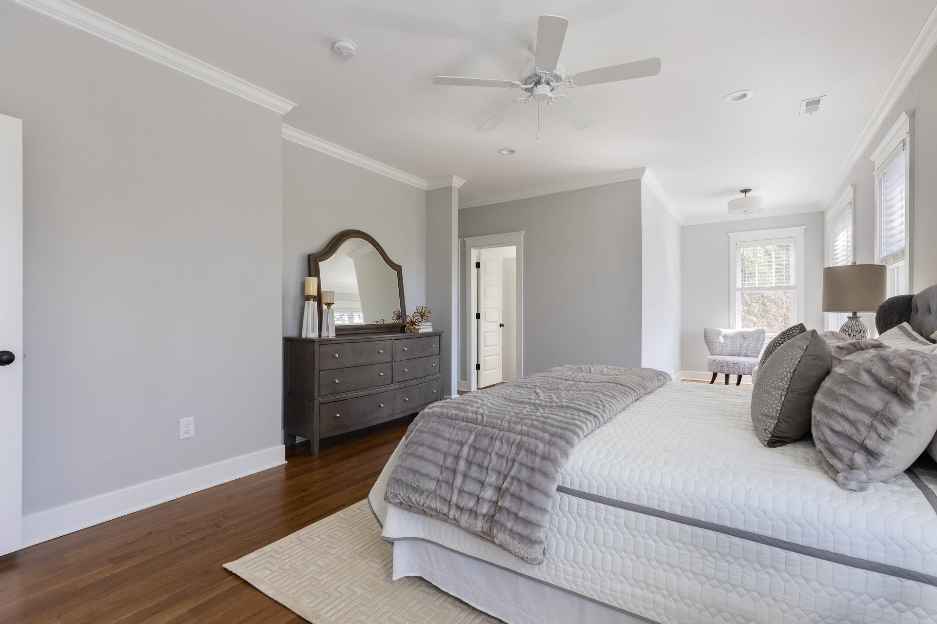 910 Sedgefield Street Durham, NC 27705 - Photo 21 of 39 a spacious bedroom with a bed a dresser and wooden floor