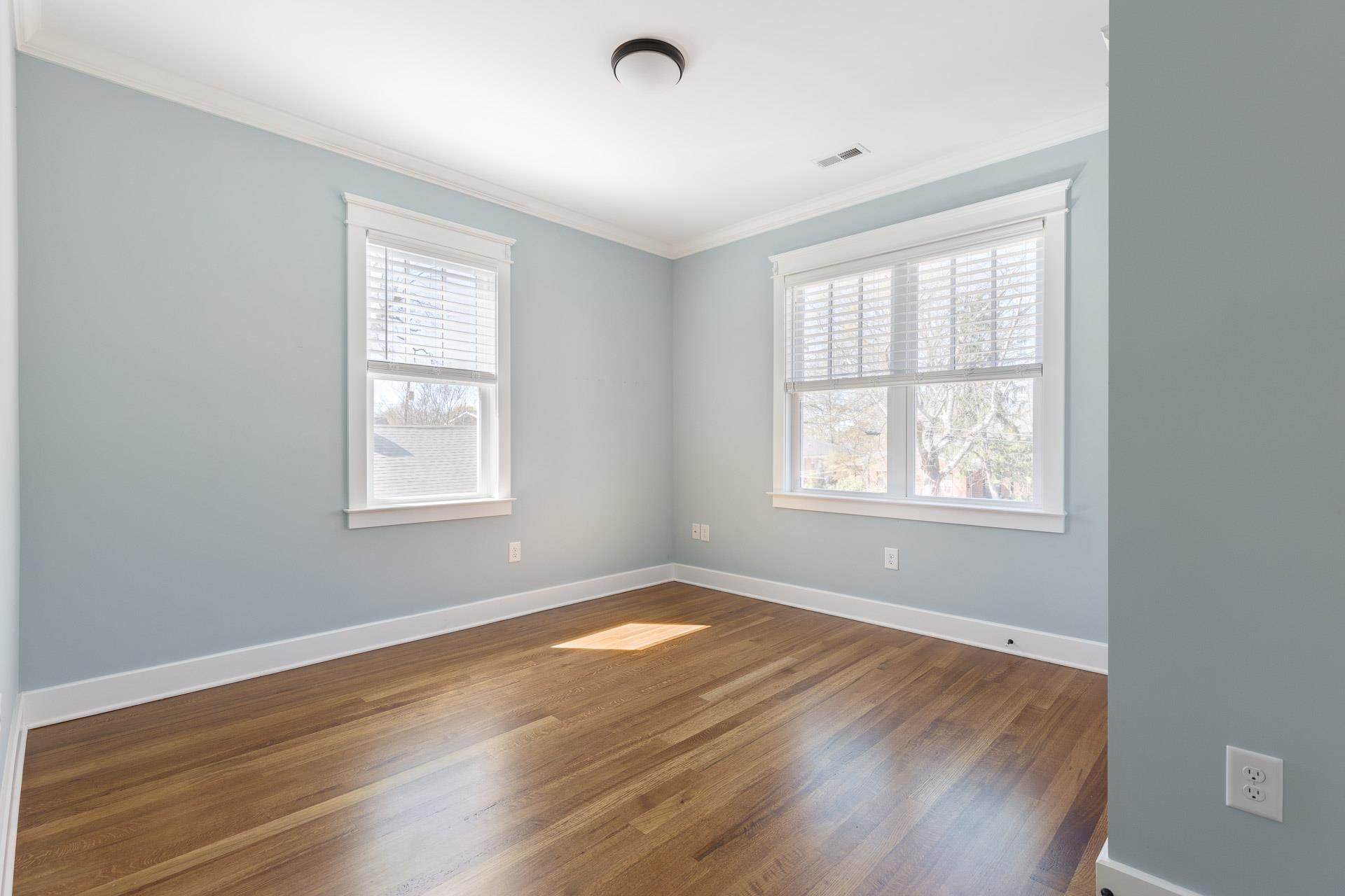 910 Sedgefield Street Durham, NC 27705 - Photo 28 of 39 a view of an empty room with wooden floor and a window