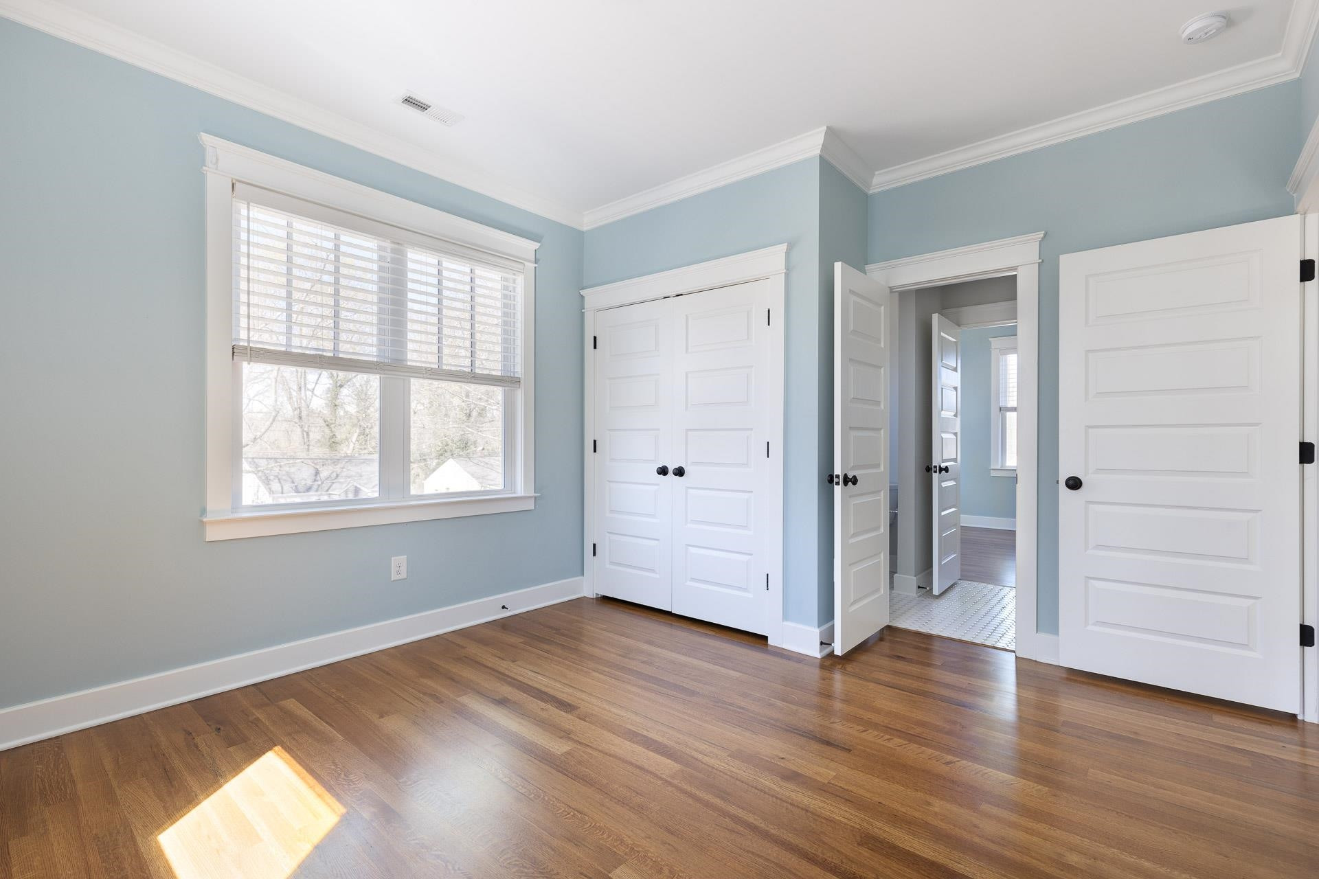 910 Sedgefield Street Durham, NC 27705 - Photo 29 of 39 a view of empty room with wooden floor and window