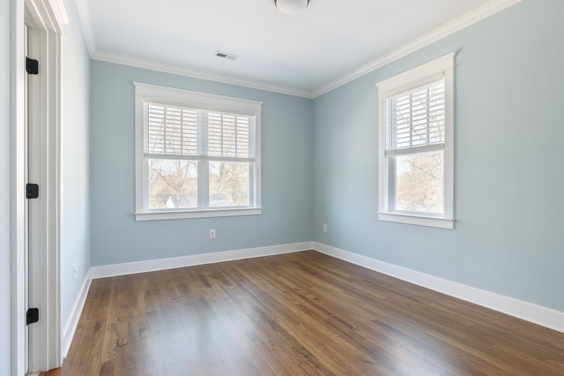 910 Sedgefield Street Durham, NC 27705 - Photo 31 of 39 a view of an empty room with wooden floor and a window