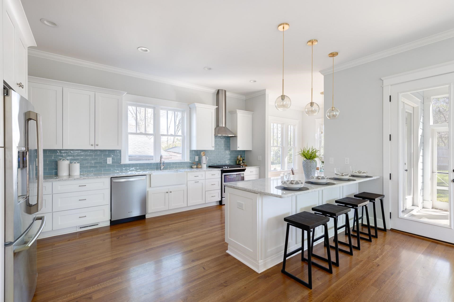 910 Sedgefield Street Durham, NC 27705 - Photo 8 of 39 a kitchen with white cabinets and wooden floor