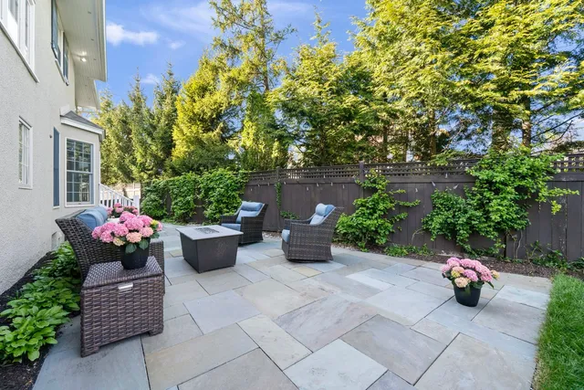 a dining room with furniture a chandelier and wooden floor