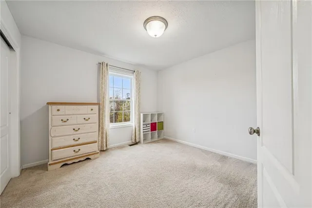 a view of a livingroom with a refrigerator
