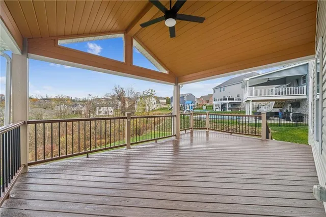 a view of staircase with lots of frames on wall and wooden floor