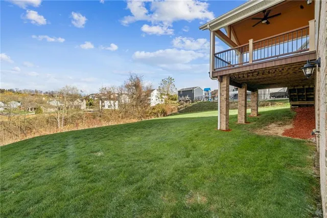 an aerial view of a house with garden space and street view