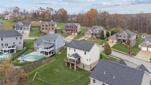 an aerial view of multiple houses with yard