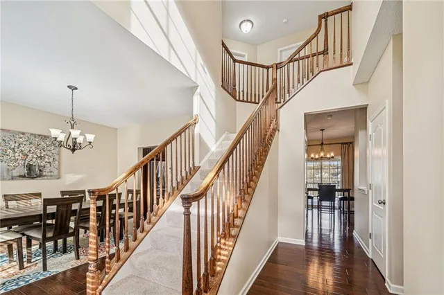 a view of staircase with lots of frames on wall and a window