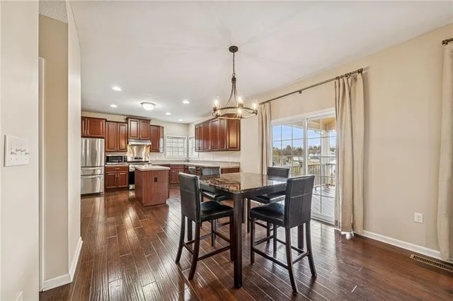 a view of a dining room with furniture and window